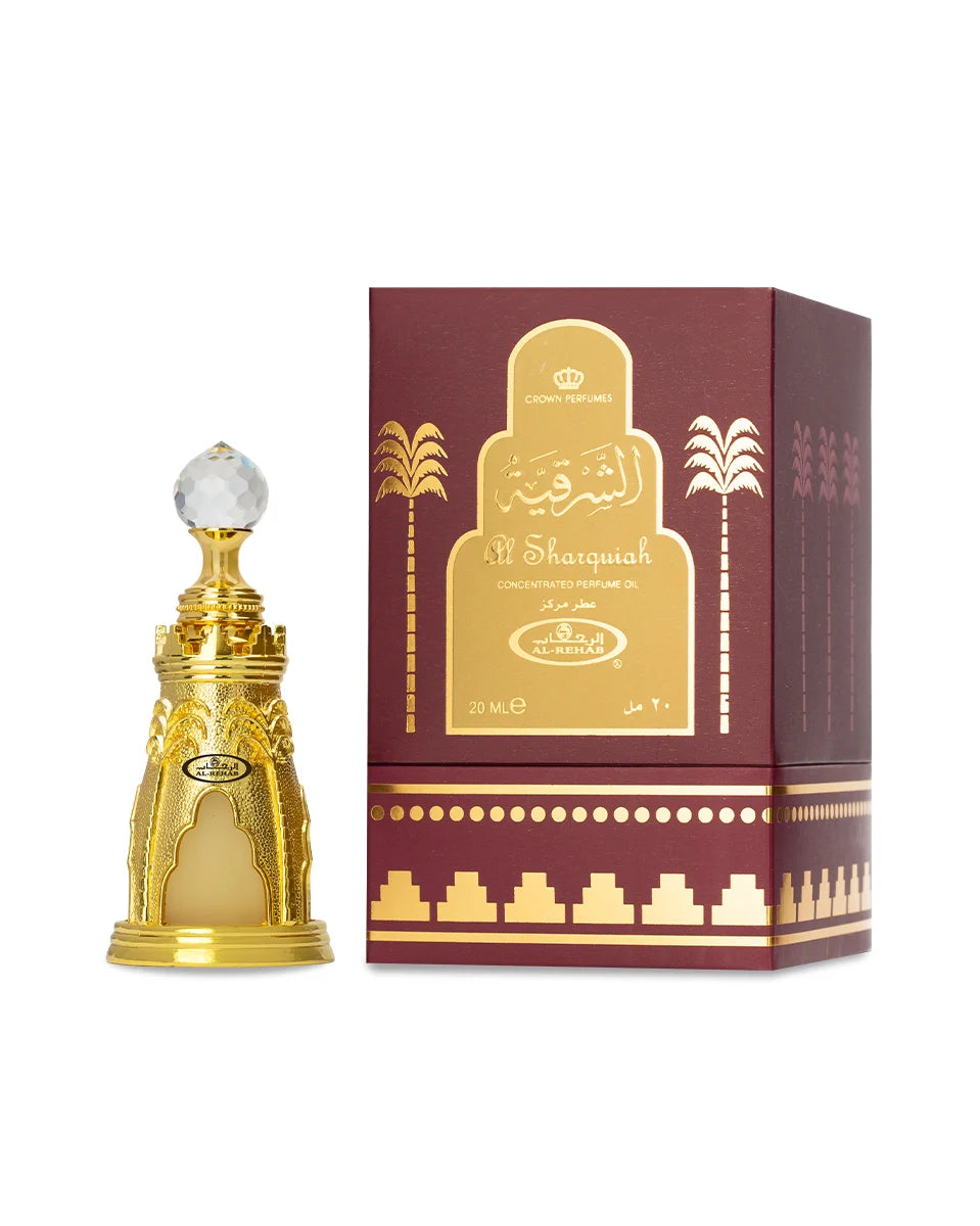 Gold perfume bottle and box with 'Sharqiah' branding on a white background